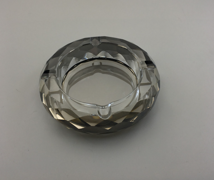 Round crystal ashtray, black faceted glass with inner metal rim