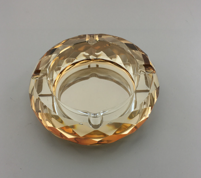 Round crystal ashtray, amber faceted glass with inner metal rim