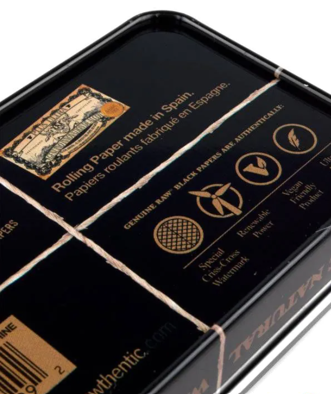 Black tin box interior with printed papers and gold seal graphics