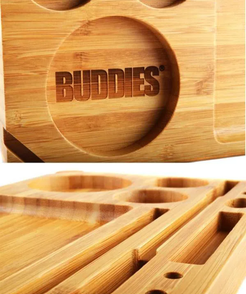 Bamboo rolling tray close-up with BUDDIES logo and small oval compartments