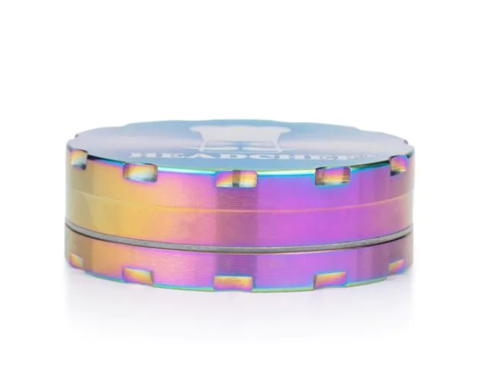 Iridescent chrome grinder lid with rainbow sheen and cutout grip notches