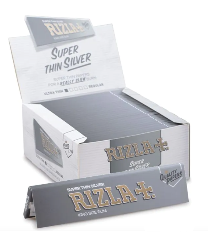 Slim rolling papers box in silver with RIZLA+ branding, open display tray
