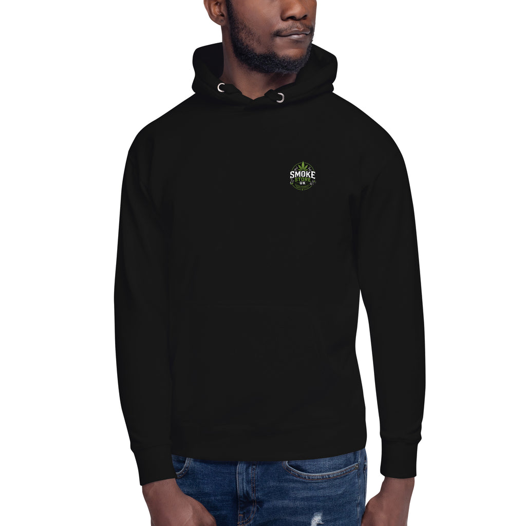 Black unisex hoodie with hood drawstring and small chest logo, worn with jeans.