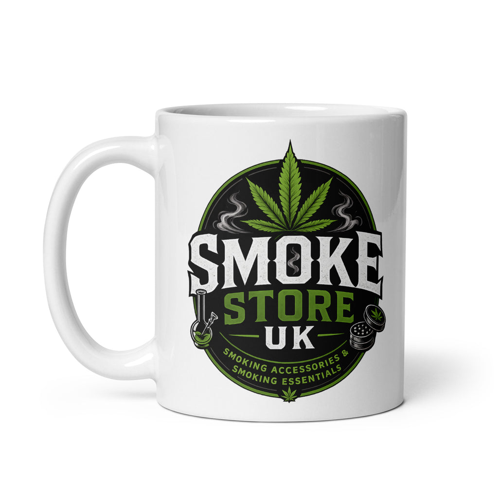 White glossy mug with green leaf “SMOKE STORE” logo graphic on front.