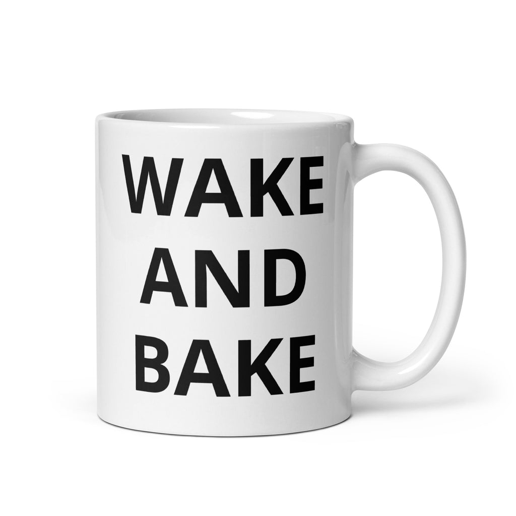 White glossy mug with bold black text reading “WAKE AND BAKE”.