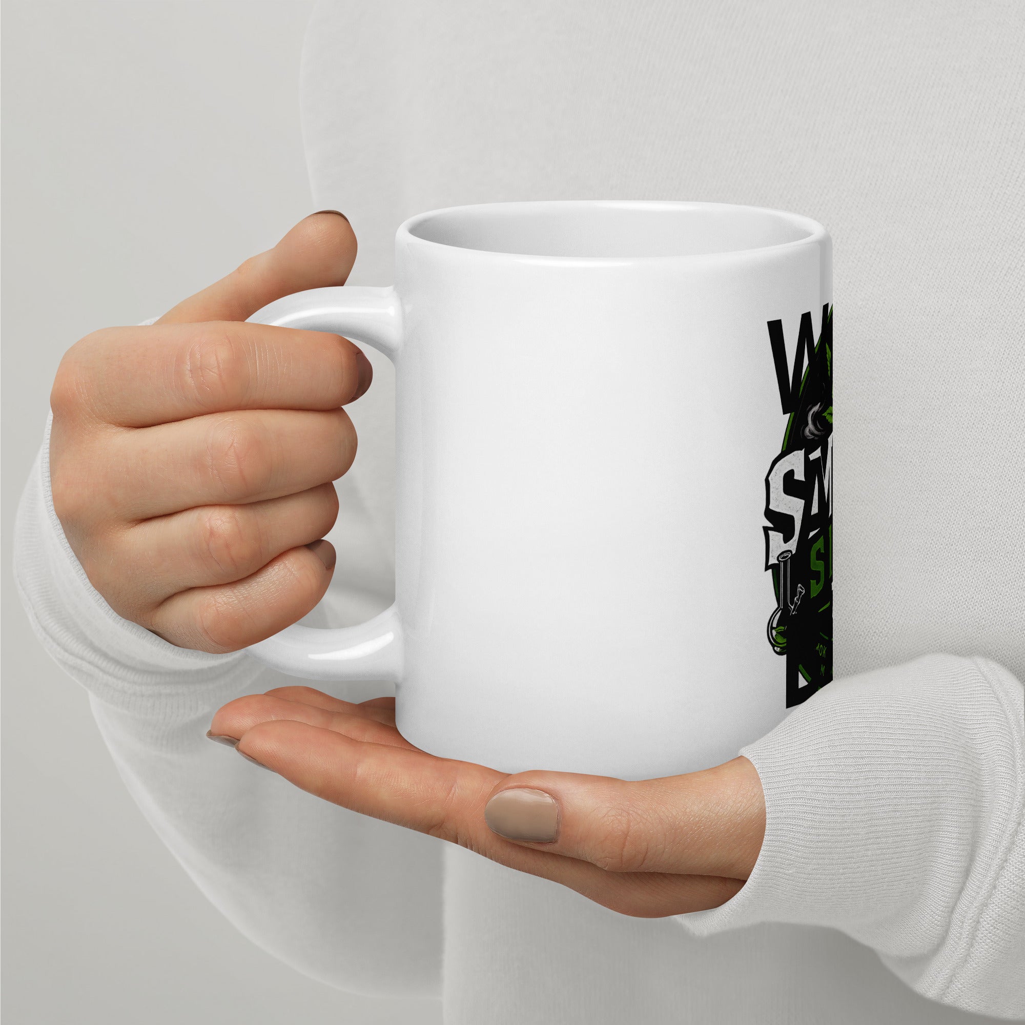 White glossy mug held in hands with partial Smoke Store UK logo