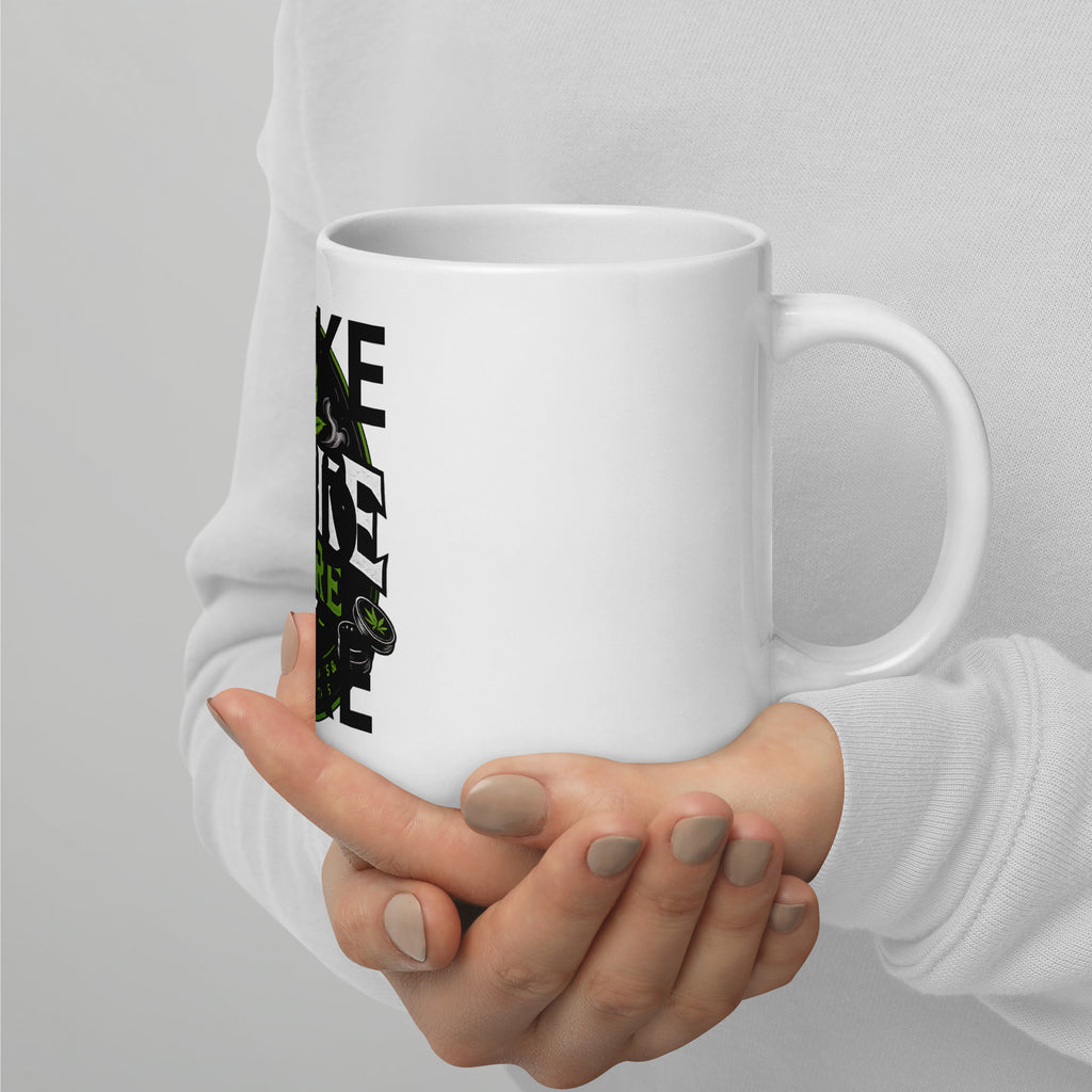 White glossy mug held in hands with partial “WAKE AND BAKE” print